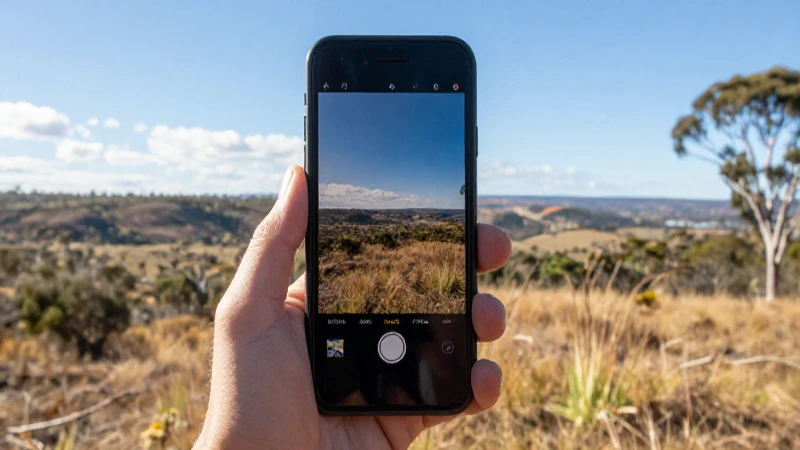 Teléfono móvil contra paisaje australiano luminoso