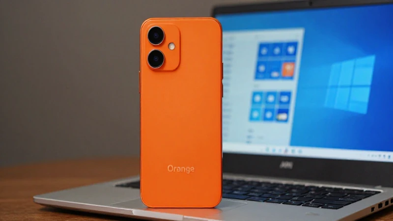 Teléfono naranja, portátil Windows y luz suave