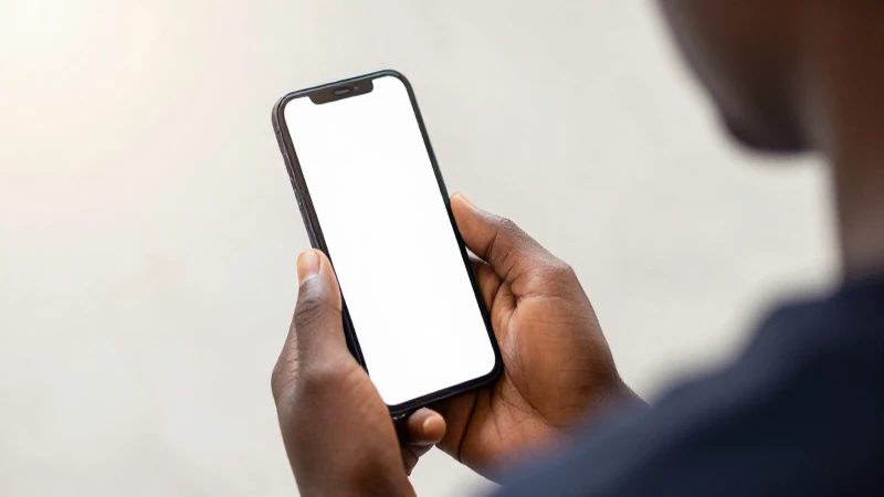 Usuario nigeriano ve pantalla iluminada suavemente
